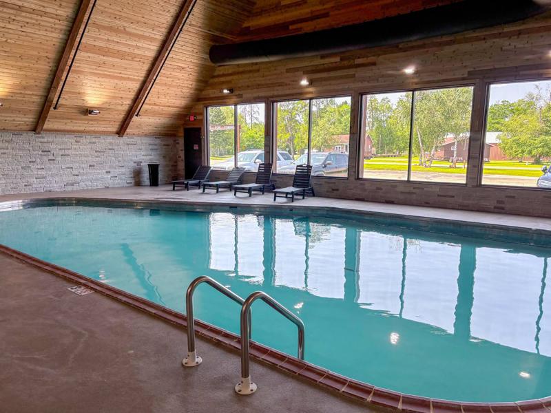 761559541_1033813149540178_3438481404054823978_n Indoor swimming pool with lounge chairs and large windows