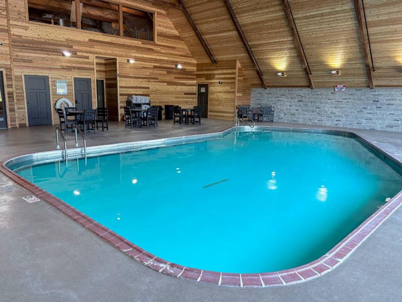 763824741_1534302854386315_6090782394183851062_n Indoor swimming pool in a rustic wood-paneled lodge